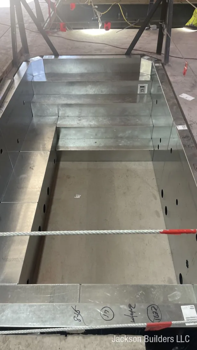 Indoor Endless Pool installation in progress with structural steel framing — Jackson Builders project photo 2