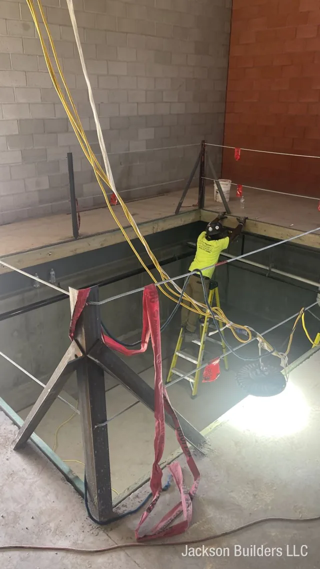 Indoor Endless Pool installation in progress with structural steel framing — Jackson Builders project photo 5